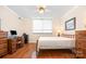 Cozy bedroom features hardwood floors, a bright window, and traditional furnishings at 1300 Reece Rd # 402, Charlotte, NC 28209