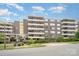 Apartment building featuring an open-air entry with multiple balconies for each unit at 1300 Reece Rd # 402, Charlotte, NC 28209
