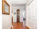 Entry hallway with coat closet, wood floors, and decorative touches at 1300 Reece Rd # 402, Charlotte, NC 28209
