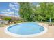 Inviting outdoor pool with ample lounging space and lush landscaping at 1300 Reece Rd # 402, Charlotte, NC 28209