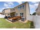 This backyard features a deck with built-in seating and is surrounded by green grass and lush landscaping at 133 Glade Valley Ave, Mooresville, NC 28117