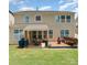 A spacious backyard features a covered patio with a table and chairs as well as a seating area with a bench at 133 Glade Valley Ave, Mooresville, NC 28117