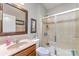 Bathroom featuring a shower with glass doors and a vanity with a large mirror at 133 Glade Valley Ave, Mooresville, NC 28117