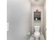 Half bath features a toilet, small cabinet for storage, and grey walls at 133 Glade Valley Ave, Mooresville, NC 28117