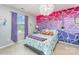 bedroom featuring a colourful geometric accent wall, a unique chandelier and a grey bed frame at 133 Glade Valley Ave, Mooresville, NC 28117