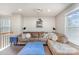 Loft living room with a large brown sectional sofa, a projector, and a bright blue ottoman at 133 Glade Valley Ave, Mooresville, NC 28117