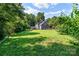 Expansive backyard featuring a well-maintained lawn, screened in porch, and fenced perimeter at 1581 Bluff Ct, Rock Hill, SC 29732