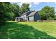 Expansive backyard featuring a well-maintained lawn, screened in porch, and rear exterior at 1581 Bluff Ct, Rock Hill, SC 29732
