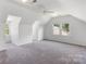 Large, sunlit bedroom with a ceiling fan and ample windows offering neighborhood views at 1581 Bluff Ct, Rock Hill, SC 29732