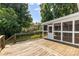 Exterior deck leading to the screened porch with wood flooring and surrounding trees at 1581 Bluff Ct, Rock Hill, SC 29732