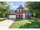 Charming two-story home with a brick and gray siding exterior, featuring a well-manicured lawn and attached garage at 1581 Bluff Ct, Rock Hill, SC 29732