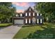 Charming two-story home with a brick and gray siding exterior, featuring a well-manicured lawn and attached garage at 1581 Bluff Ct, Rock Hill, SC 29732