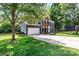 View of the home's exterior featuring a two-car garage, driveway, brick facade, and a well-maintained lawn at 1581 Bluff Ct, Rock Hill, SC 29732