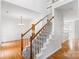 Inviting foyer with hardwood floors, staircase, and view of the dining area with elegant chandelier at 1581 Bluff Ct, Rock Hill, SC 29732