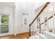 Foyer with hardwood floors, elegant door, and staircase welcome you home at 1581 Bluff Ct, Rock Hill, SC 29732