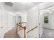 Bright hallway boasts neutral carpet, white walls and trim, and wood railing at 1581 Bluff Ct, Rock Hill, SC 29732