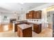 Open kitchen with island features granite counters and stainless steel appliances at 1581 Bluff Ct, Rock Hill, SC 29732