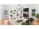 Bright living room with a fireplace, plush sofa, accent chairs, and hardwood flooring at 1581 Bluff Ct, Rock Hill, SC 29732
