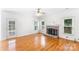 Bright living room features hardwood floors and a traditional brick fireplace at 1581 Bluff Ct, Rock Hill, SC 29732