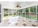 Bright and airy sunroom with tile flooring and many windows overlooking the outdoor greenery at 1581 Bluff Ct, Rock Hill, SC 29732
