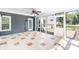 Enclosed sunroom featuring tiled floors, a ceiling fan, screened windows, and an exterior door at 1581 Bluff Ct, Rock Hill, SC 29732