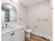 Bathroom with a vanity, new sink, mirror, toilet, flooring and fixtures at 1606 N Rhyne St, Gastonia, NC 28054