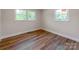 A bedroom with two windows allowing ample sunlight, complemented by modern wood flooring at 1606 N Rhyne St, Gastonia, NC 28054