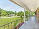 Inviting covered front porch with decorative iron railing and column supports at 1606 N Rhyne St, Gastonia, NC 28054