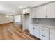 Open kitchen with white cabinetry, stainless appliances, and seamlessly adjoined living area at 1606 N Rhyne St, Gastonia, NC 28054