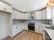 A kitchen featuring white cabinets, stainless steel appliances, and modern countertops at 1606 N Rhyne St, Gastonia, NC 28054