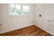 Bright laundry room with wood floors and laundry hookups at 1606 N Rhyne St, Gastonia, NC 28054