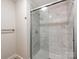 Bathroom with white marble tiled shower and glass doors at 1606 N Rhyne St, Gastonia, NC 28054
