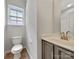 Features a well-lit half-bath with a modern vanity and a window at 16815 Spruell St, Huntersville, NC 28078