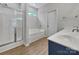 Bathroom with a separate shower and tub, double sink vanity, and wood-look flooring at 16815 Spruell St, Huntersville, NC 28078