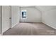 The bedroom has neutral carpet and a window that provides ample natural light at 16815 Spruell St, Huntersville, NC 28078
