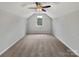 Cozy bedroom features a ceiling fan and natural light from a single window at 16815 Spruell St, Huntersville, NC 28078