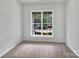Clean, carpeted bedroom featuring a large window and neutral walls, ready for personalization at 16815 Spruell St, Huntersville, NC 28078