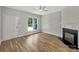 Bright living room with a fireplace, a ceiling fan and large windows for natural light at 16815 Spruell St, Huntersville, NC 28078