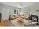 Bright living room with neutral decor, a cozy fireplace, and large windows for natural light at 16815 Spruell St, Huntersville, NC 28078