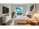 Serene main bedroom with neutral tones, stylish decor, and ample natural light from the large window at 16815 Spruell St, Huntersville, NC 28078