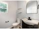 Stylish half bathroom with a modern sink, black hardware, and natural light at 172 Briana Marie Way, Indian Trail, NC 28079