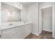 Bright bathroom featuring a double sink vanity with modern fixtures and wood flooring at 172 Briana Marie Way, Indian Trail, NC 28079