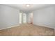 Neutral bedroom with carpet, white trim, and ample doorway access at 172 Briana Marie Way, Indian Trail, NC 28079