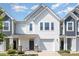 Charming two-story townhouse with white siding, garage, well-manicured lawn, and a covered porch at 172 Briana Marie Way, Indian Trail, NC 28079