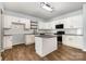 Bright kitchen with an island, white cabinets, granite counters, stainless steel appliances, and modern light fixtures at 172 Briana Marie Way, Indian Trail, NC 28079