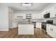 Bright kitchen features white cabinets, granite countertops, a kitchen island, and stainless steel appliances at 172 Briana Marie Way, Indian Trail, NC 28079
