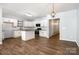 Modern kitchen with white cabinets, stainless steel appliances, subway tile backsplash and spacious island at 172 Briana Marie Way, Indian Trail, NC 28079
