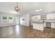 Open-concept space with kitchen, living area, wood-look floors, and natural light at 172 Briana Marie Way, Indian Trail, NC 28079