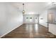 Spacious living room with wood-look floors, large windows, and modern light fixtures at 172 Briana Marie Way, Indian Trail, NC 28079