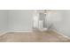Open loft area with neutral carpet and staircase access at 172 Briana Marie Way, Indian Trail, NC 28079